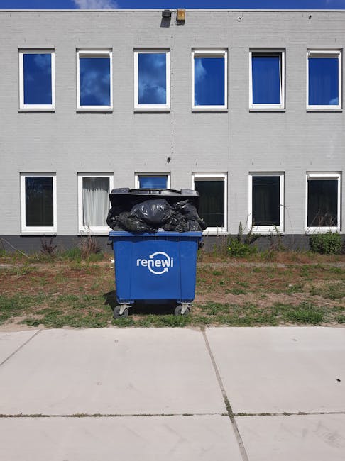 A large collection of mixed waste and rubbish bags, including black plastic sacks, flattened cardboard boxes, paper and packaging materials, and a few loose items such as cardboard and plastic contain
